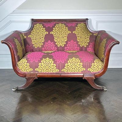 AMERICAN EMPIRE STYLE CARVED WOOD SETTEE | Circa mid-19th century (c. 1840 - 1860), Carved hardwood frame; reupholstered seat and back,...