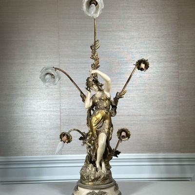 AFTER AUGUSTE MOREAU FIGURAL LAMP | Having figure of a woman surrounded by 5 flower-form lights - h. 39 x w. 22 x d. 10 in.
