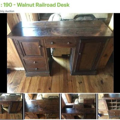 Lot # : 190 - Walnut Railroad Desk
2 doors concealing alphabetical cubbies, 3 drawers, 2 deep compartments under sections of desk top and...