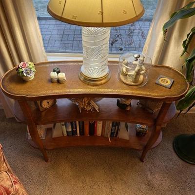 Vintage kidney shape three-tier accent table with leather top. $75.
