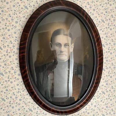 Antique tiger wood oval frame with convex bubble glass with vintage female sepia portrait. $125. Replacement glass alone costs $120, so...