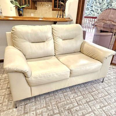 Ashley Furniture Cream Colored Leather-Look Love Seat with Contemporary Chrome Legs