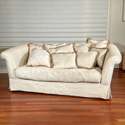 Sofa | Cream colored damask sofa. One full cushion with zipper. Pillows included. Flat apron. - h. 33 x l. 84 x d. 48 in

