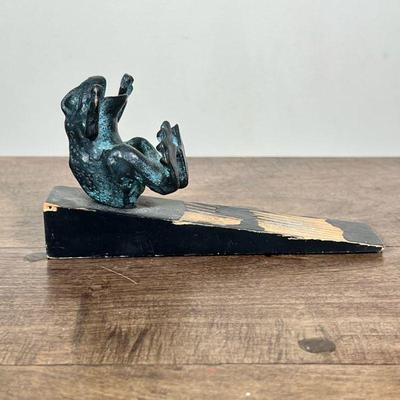 FROG DOORSTOP | Wood doorstop with cast brass frog Dimensions: h. 3.25 x w. 2.5 x l. 6.25 in.
