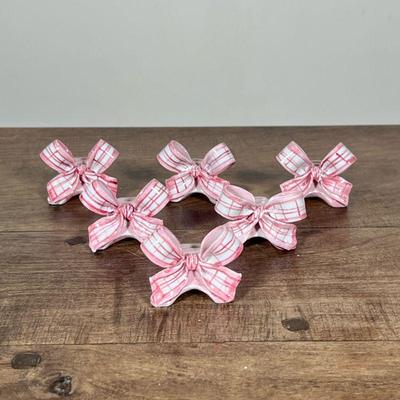 (6pc) PORCELAIN PLACE CARD HOLDERS | Glazed porcelain place card holders in the form of a bow. Dimensions: h. 1.75 x w. 1 x l. 2 in
