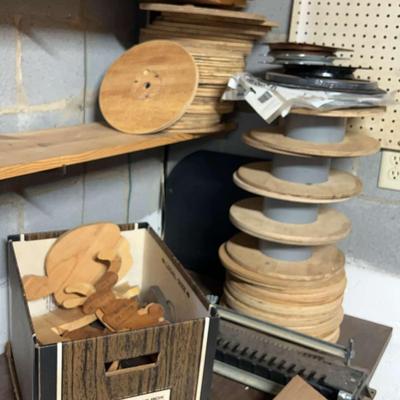 Homemade Spools, Several Circular Pieces Of Wood, And A Crafting Tool For Leather 