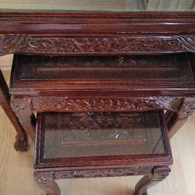 THREE CARVED DARK WOOD STACKING TABLES