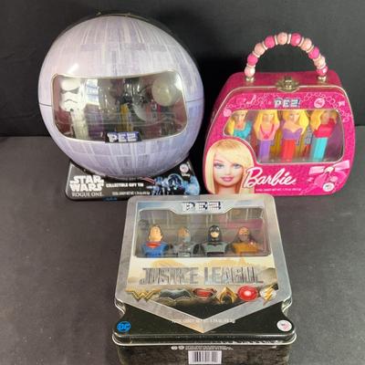 Three sets of PEZ collectibles featuring Star Wars rug, one the justice league tice league and Barbie