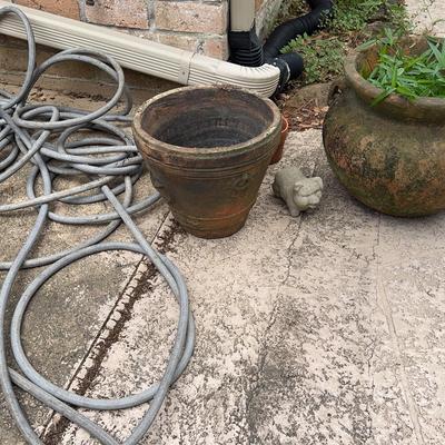 Pots, Garden Hose And A Piggy