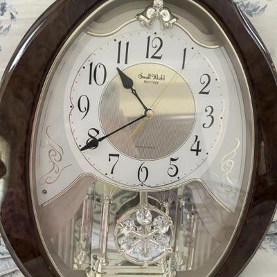 Oval wall clock brown wood casing
