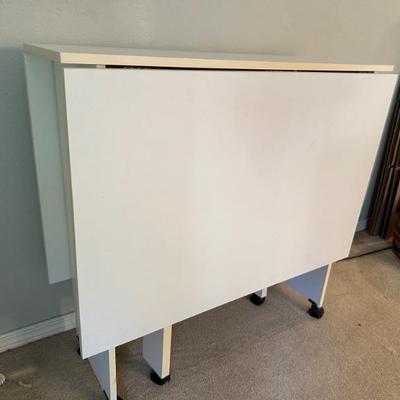 Rolling white folding table in excellent condition
