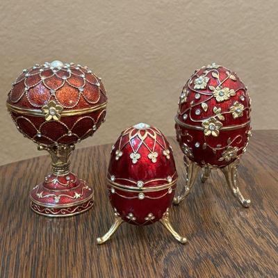 Lot #16 - Set of Three Red Enamel Reproduction Faberge Egg Musical Jewelry Boxes & Trinket Box