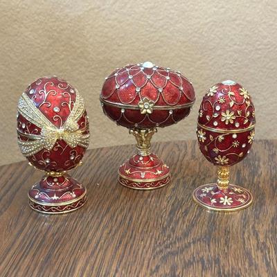 Lot #15 - Set of Three Red Enamel Reproduction Faberge Egg Musical Jewelry Boxes