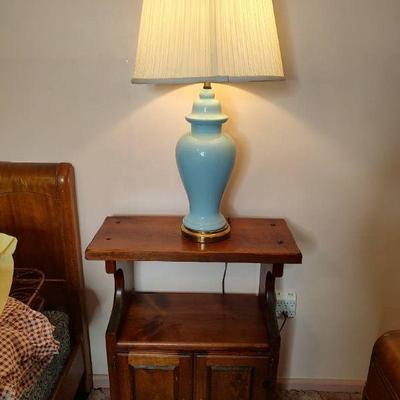Narrow nightstand with blue lamp