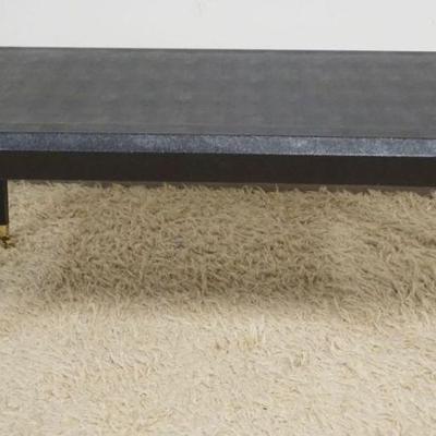 1127	EBONY DEISGNER STYLE TAPER LEGGED COFFEE TABLE WITH TEXTURED FINISH ON BRASS CASTERS, APPROXIMATELY 40 IN X 20 IN X 17 IN H
