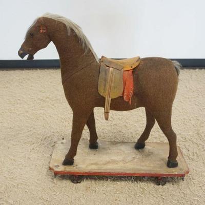 1112	ANTIQUE CHILDS HORSE ON WOOD BASE WITH CAST METAL WHEELS, APPROXIMATELY 26 IN X 12 IN X 31 IN H
