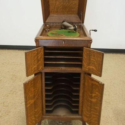 1097	VICTOR VV-XI FLOOR MODEL VICTROLA IN OAK CASE WITH RECORDS, 1 LEG REPAIRED, APPROXIMATELY 19 IN X 23 IN X 43 IN H
