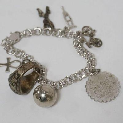 1204	STERLING SILVER CHARM BRACELET AND CHARMS, INCLUDIING HIGH SCHOOL RING, 1.04 OZT, APPROXIMATELY 7 IN L
