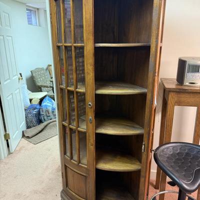 Antique corner cabinet with adjustable shelves and rounded glass