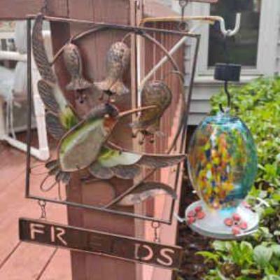 Welcome sign and hummingbird feeder