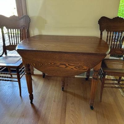 Antique drop leaf dining table with many additional original leaves to expand!