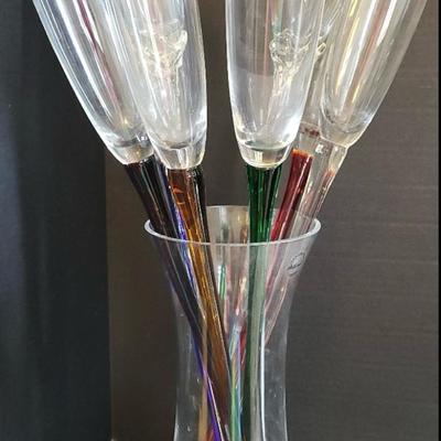 Six glasses and two plastic long stemmed champagne glasses with vase