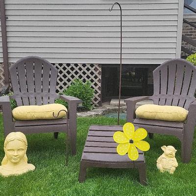 Two plastic adirondack chairs, foot rest and yard art