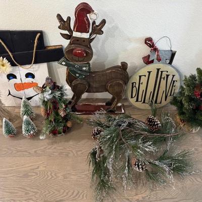 Wooden Reindeer, Snowman Plaque, Metal Sign, And Holiday Greenery