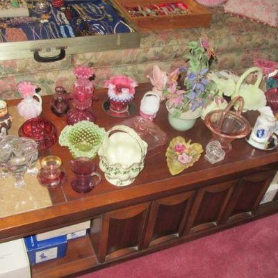 Steffans table full of fenton and glass