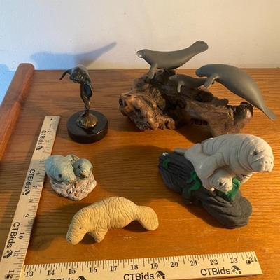 Collection of Manatee Figurines in Various Materials