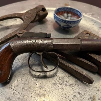 19th century pre-Civil War single shot pistol by Bacon & Co, polished wooden grips decorated with chased and engraved metal work....