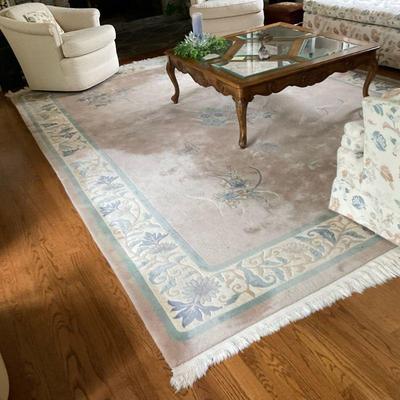 Rose-Colored Oriental Rug - Area | Oriental area rug (8' x 12') with blue florals atop a rose-colored base with white tasseled...