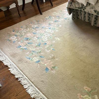 Floral Patterned Area Rug | Area rug (approximately 8' x 11') with blue and pink floral pattern atop a beige/tan-colored base...