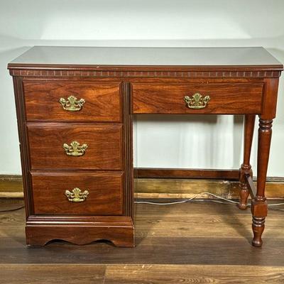 Four-Drawer Wooden Desk | Four-drawer wooden desk with gold hardware and carved details. - h. 31 x w. 40.75 x d. 17 in

