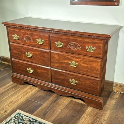 Six-Drawer Wooden Dresser | Six-drawer wooden dresser with gold hardware and carved details. - h. 31 x w. 50 x d. 17 in
