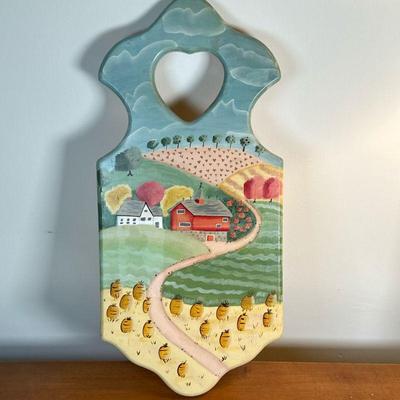 Folk Art Painted Cutting Board | Folk art hand-painted cutting board of a farm and surrounding farmlands. - h. 22.25 x w. 10 in