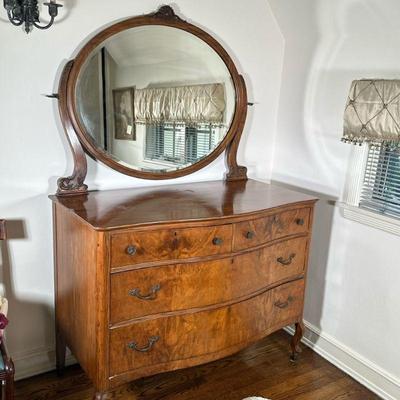 Serpentine Front Dresser With Mirror | Vintage burlwood four-drawer dresser with serpentine front, hardware and attached oval-shaped...