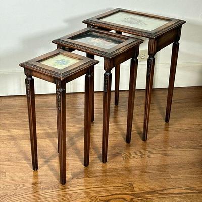 (3pc) Nesting Tables with Needlepoint Design | Three (3) nesting tables, each with a unique needlepoint design beneath glass table tops....