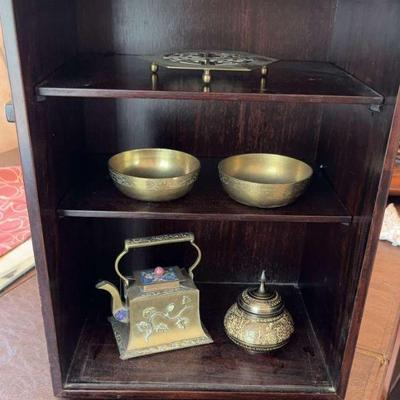 Small locking wood cabinet with brass collectibles