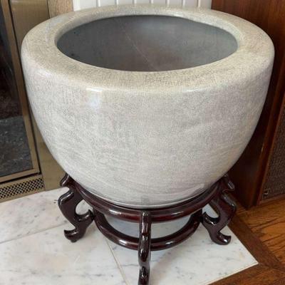 Large ceramic pot with wood base