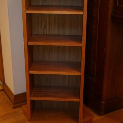 This teak shelf rotates and is for CDS or smaller books, 