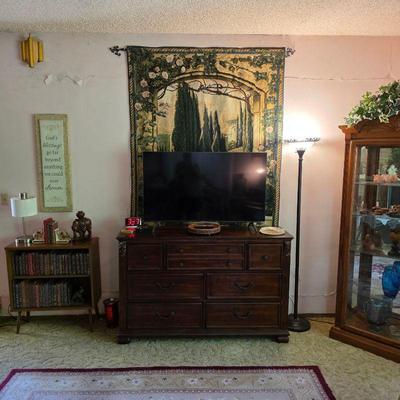 Flat screen TV, dresser, wall tapestry