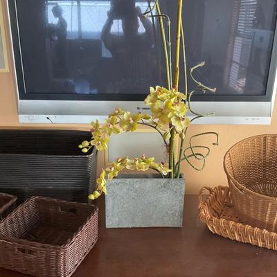 Faux Orchid And Decorative Ratan Baskets