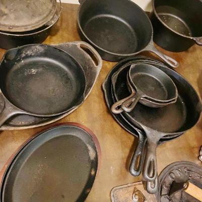 large selection of cast iron skillets and dutch oven