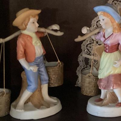 Figurine boy and girl carring baskets