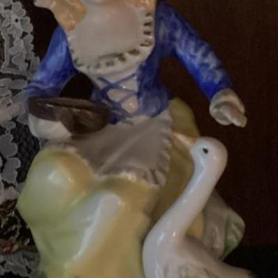 Figurine girl in blue with goose