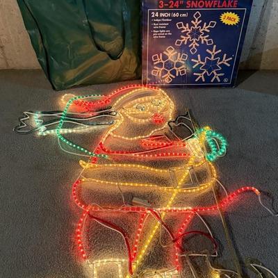 Lighted Christmas Decor With Skiing Santa, Snowflakes, And Collapsible Tree