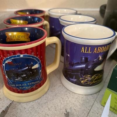 Several years of the Polar Express mugs