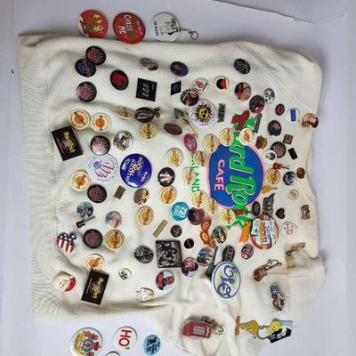 Hard Rock Pins & Buttons Collection with Miscellaneous Keychains on Sweatshirt