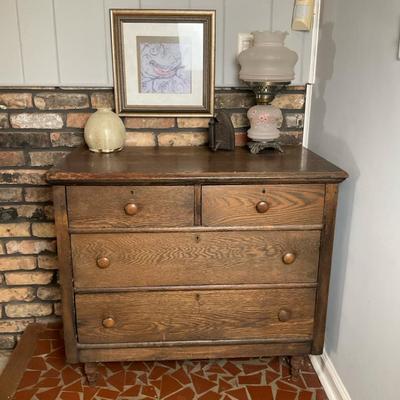 Oak chester drawers with lamp , art,  and pottery